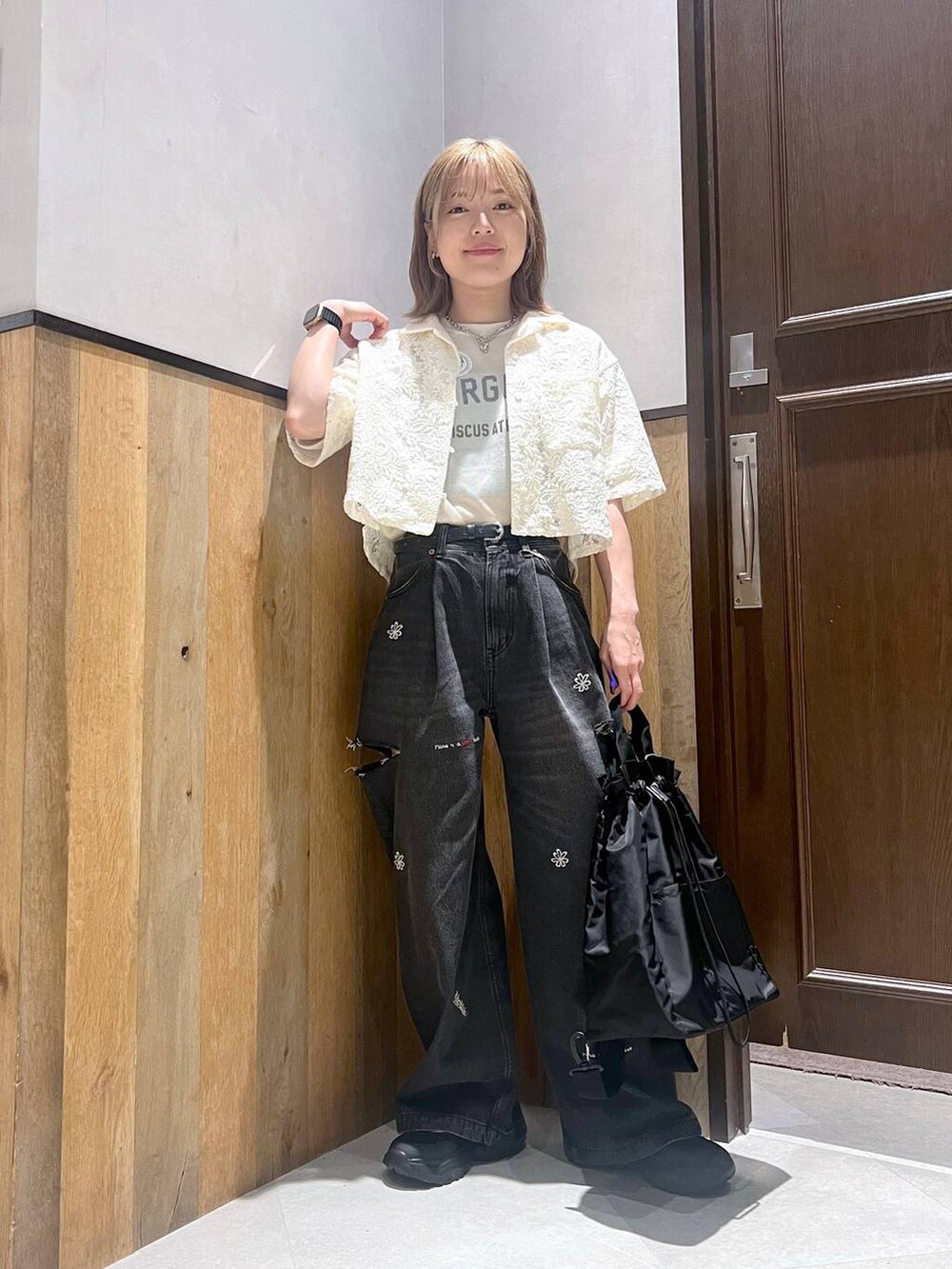 ブラック系のショルダーバッグ、ブラック系のスニーカー、ホワイト系のTシャツ/カットソーを着用したレディースの夏コーディネートの2枚目の写真