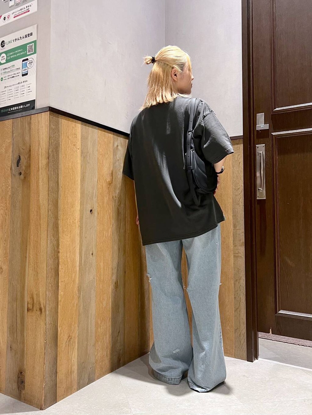 ブラック系のサンダル、ブルー系のデニムパンツ、ブラック系のショルダーバッグを着用したレディースの夏コーディネートの4枚目の写真