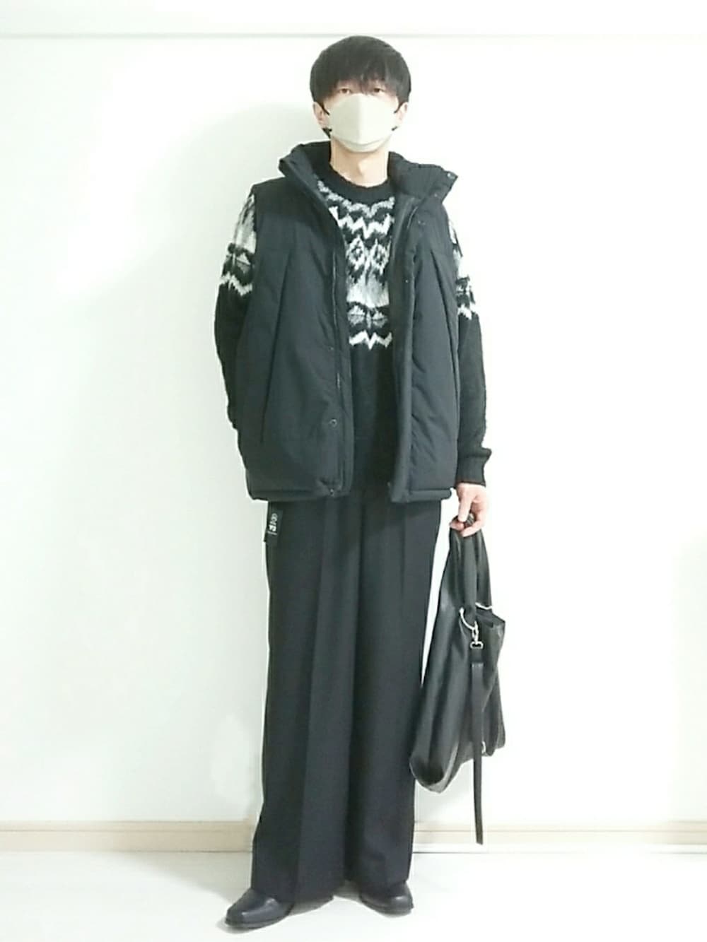 ブラック系のブーツ、ブラック系のスラックス、ブラック系のニット/セーターを着用したメンズの冬コーディネートの4枚目の写真