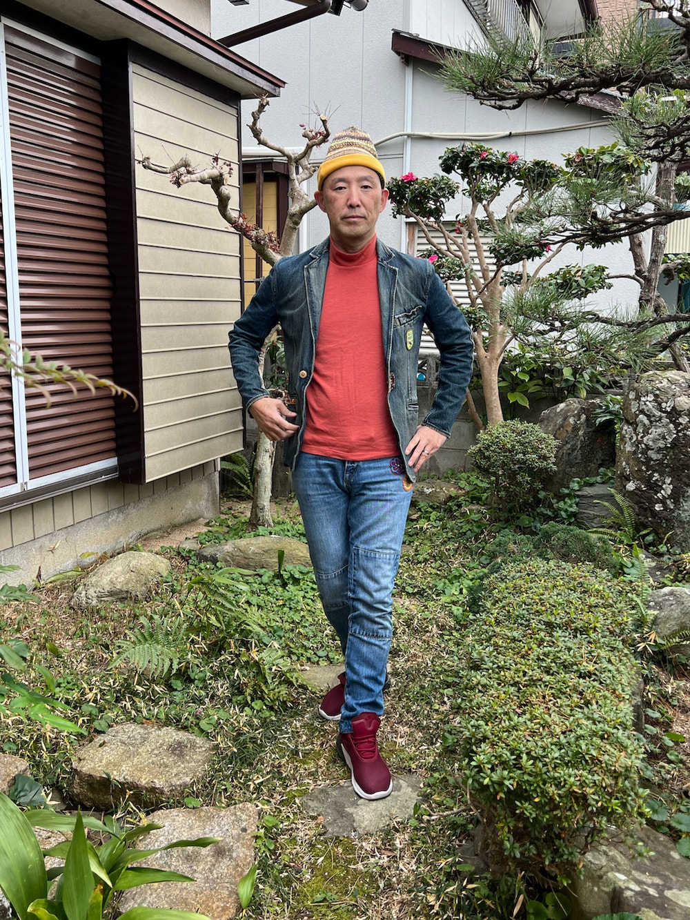 オレンジ系のTシャツ/カットソー、ブルー系のデニムジャケット、ブルー系のデニムパンツを着用したメンズの冬コーディネートの2枚目の写真