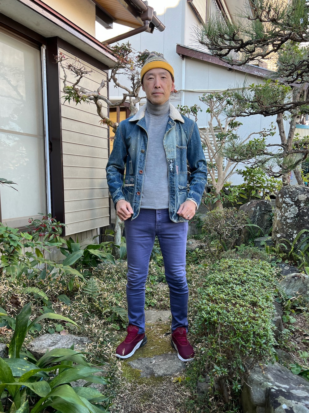 ブルー系のデニムジャケット、グレー系のニット/セーター、ブルー系のデニムパンツを着用したメンズの冬コーディネートの2枚目の写真