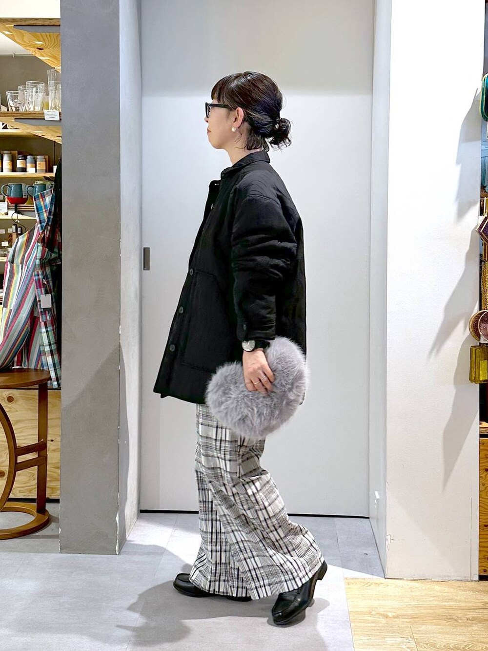 グレー系のハンドバッグ、ホワイト系のTシャツ/カットソー、ブラック系のその他パンツを着用したレディースの秋コーディネートの3枚目の写真