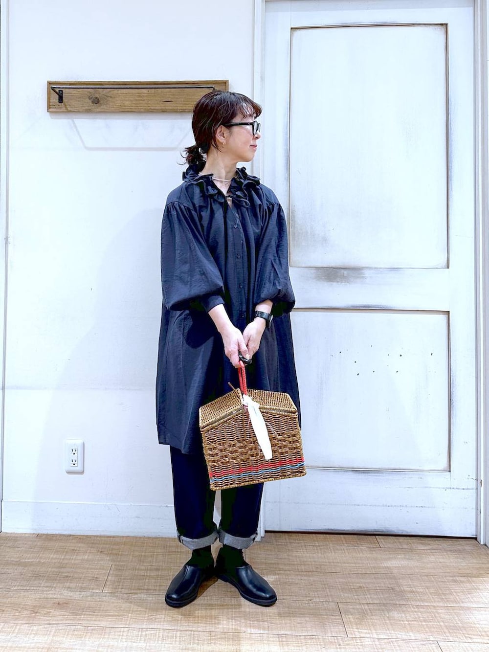 ブルー系のデニムパンツ、ブラック系のスリッポン、ブルー系のワンピースを着用したレディースの春コーディネートの5枚目の写真