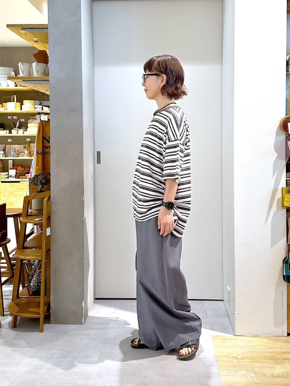ブラック系のショルダーバッグ、グレー系のTシャツ/カットソー、グレー系のその他パンツを着用したレディースの夏コーディネートの2枚目の写真