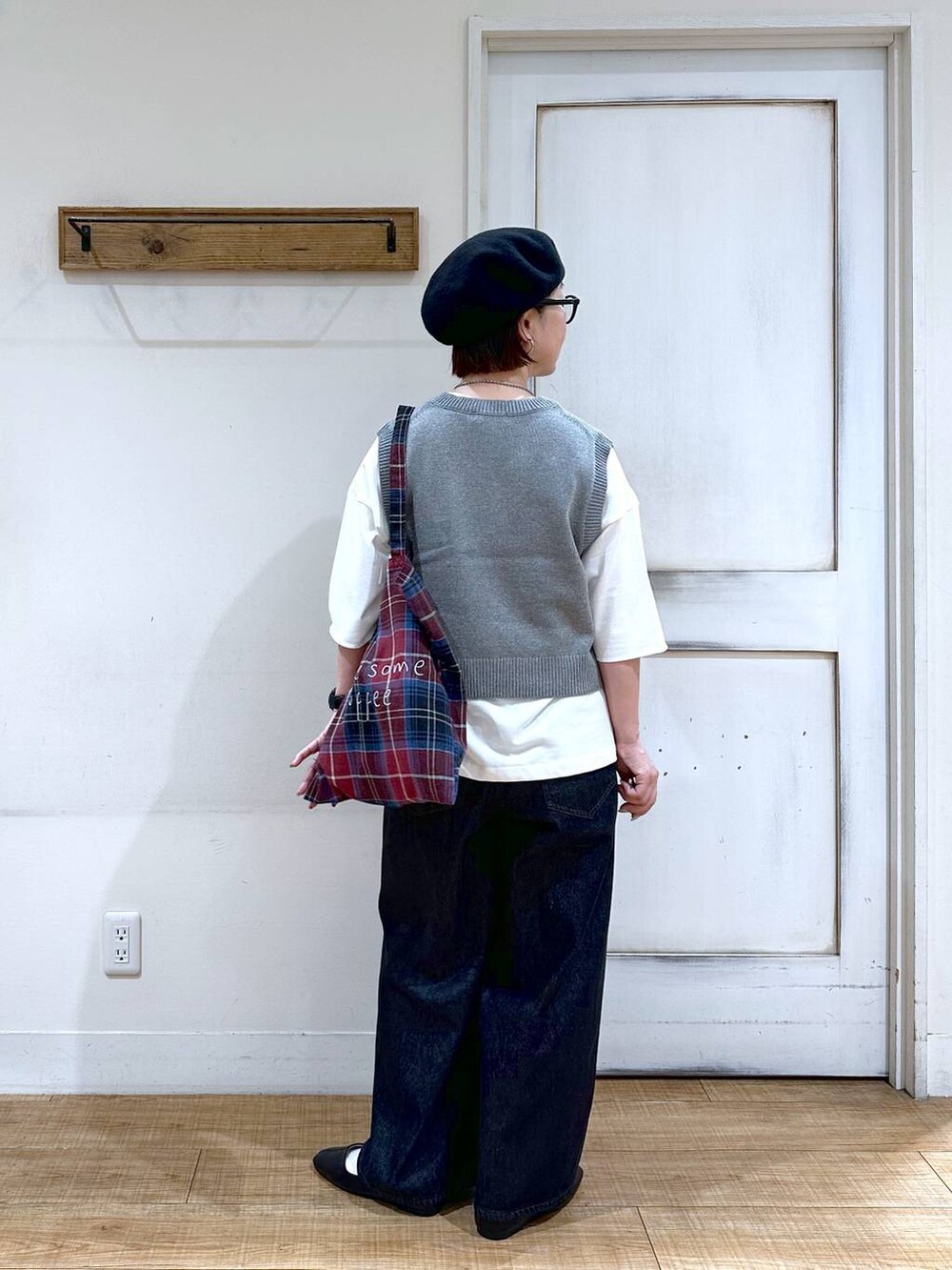 ホワイト系のTシャツ/カットソー、グレー系のベスト、ブラック系のパンプスを着用したレディースの秋コーディネートの2枚目の写真