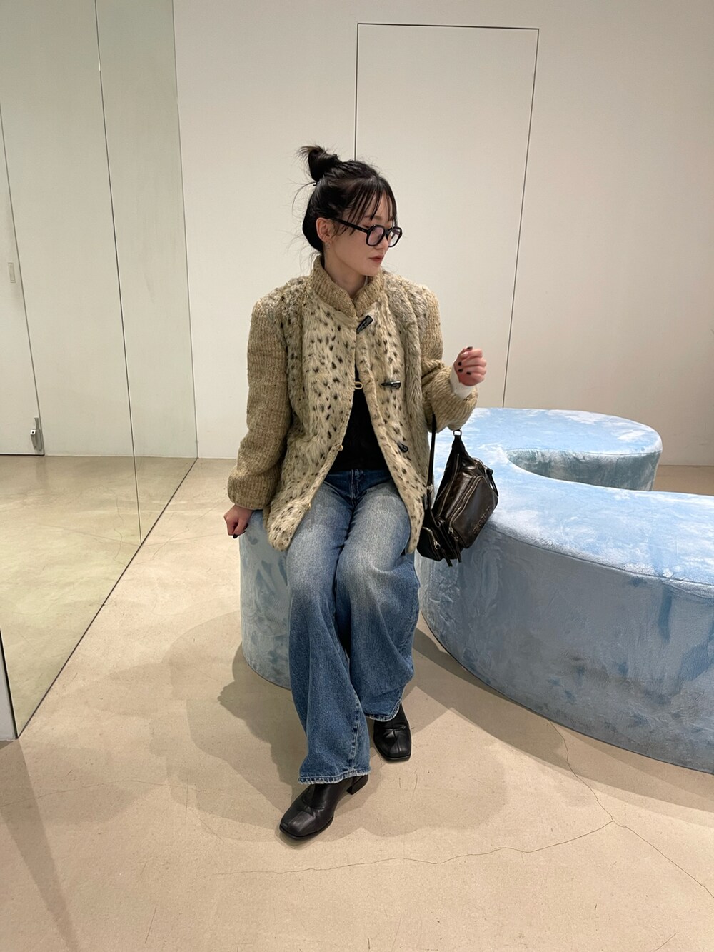 ベージュ系のジャケット/アウター、ブルー系のデニムパンツ、ブラウン系のバッグを着用したレディースの春コーディネートの2枚目の写真