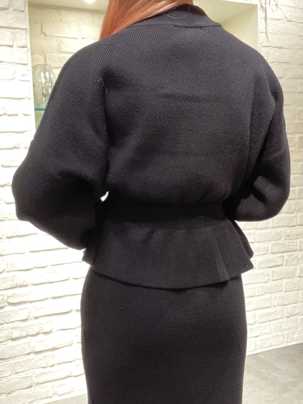 ブラック系のワンピース、ベージュ系のショルダーバッグ、ホワイト系のブーツを着用したレディースの秋コーディネートの6枚目の写真