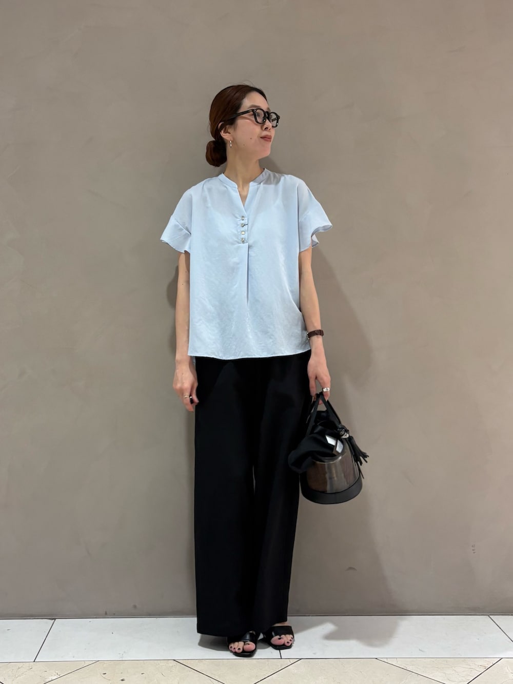 ブルー系のシャツ/ブラウス、ブラック系のその他パンツ、ブラック系のかごバッグを着用したレディースの夏コーディネートの2枚目の写真