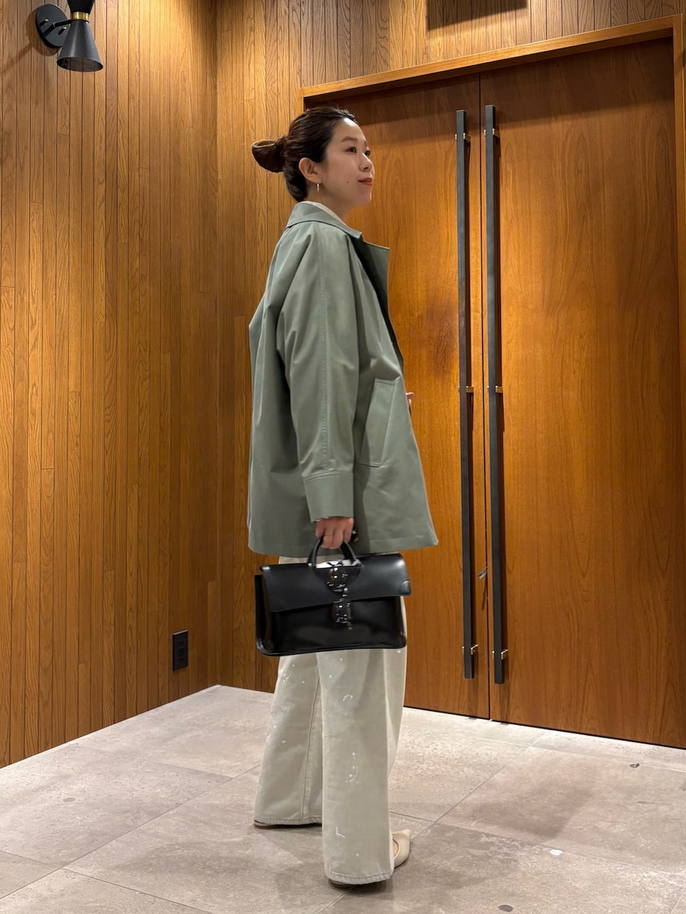 グレー系のシャツ/ブラウス、グレー系のデニムパンツ、ブラック系のハンドバッグを着用したレディースの冬コーディネートの2枚目の写真