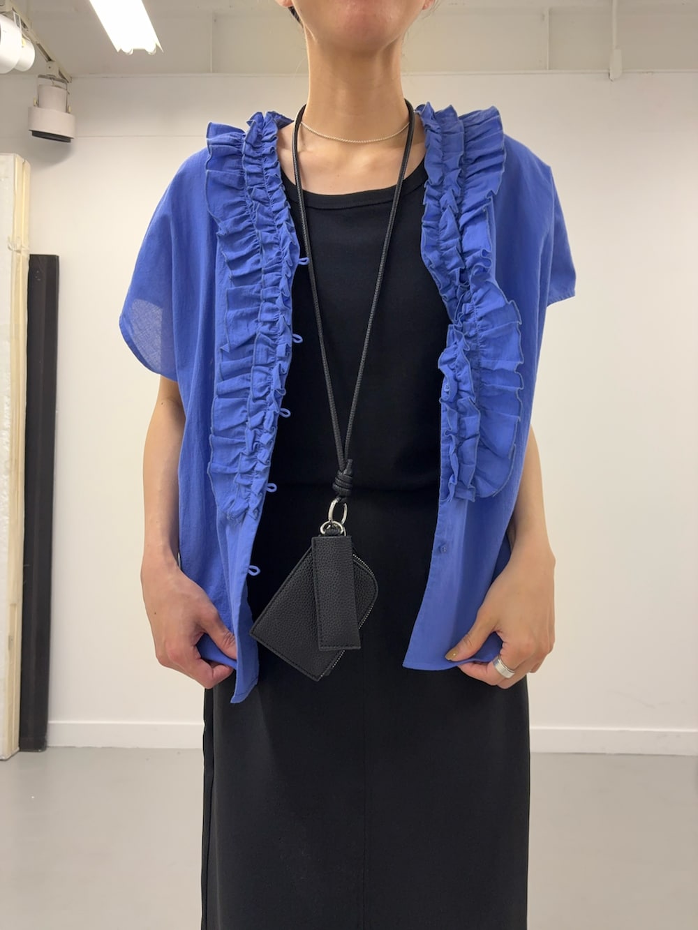 ブルー系のシャツ/ブラウス、ブラック系のショルダーバッグ、ブラック系のサンダルを着用したレディースの春コーディネートの5枚目の写真