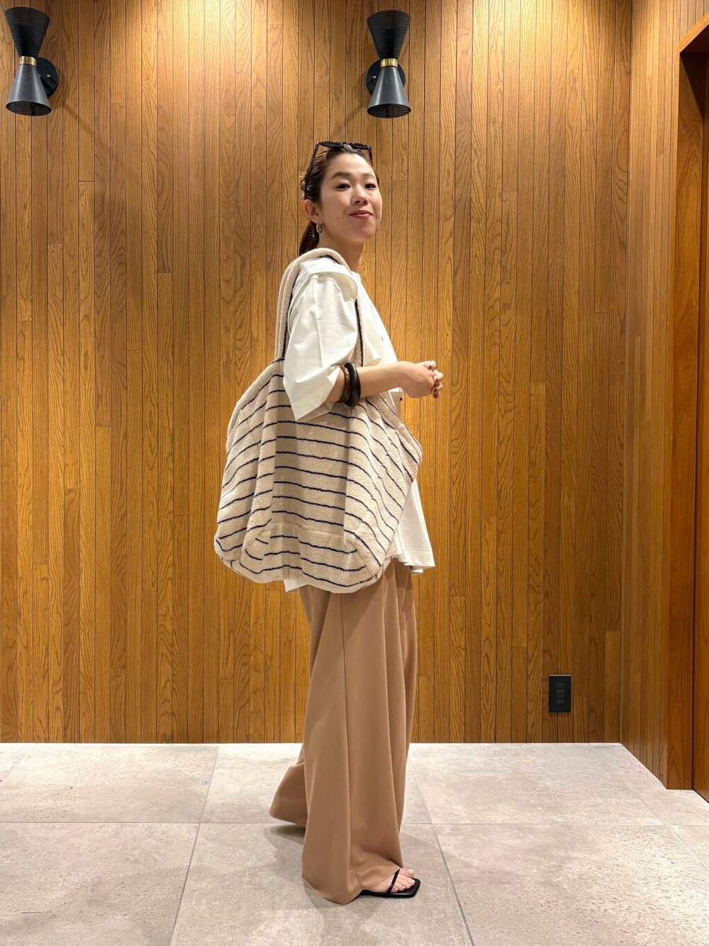 ホワイト系のTシャツ/カットソー、イエロー系のその他パンツ、シルバー系のネックレスを着用したレディースの夏コーディネートの2枚目の写真