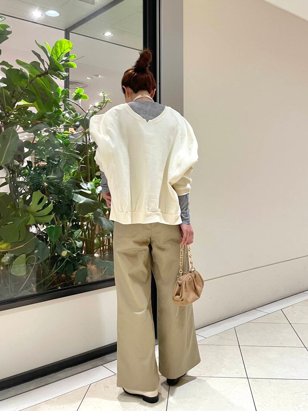 ベージュ系のその他パンツ、ホワイト系のその他シューズ、ホワイト系のTシャツ/カットソーを着用したレディースの秋コーディネートの5枚目の写真