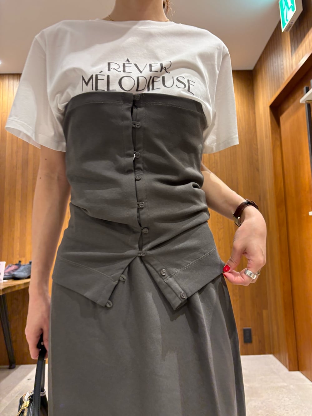 グレー系のスカート、その他のTシャツ/カットソー、ブラック系のハンドバッグを着用したレディースの春コーディネートの7枚目の写真