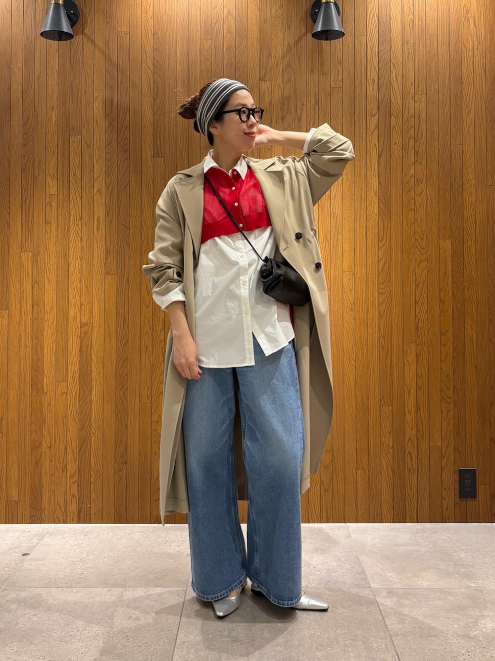ベージュ系のトレンチコート、ブルー系のデニムパンツ、シルバー系のパンプスを着用したレディースの春コーディネートの6枚目の写真