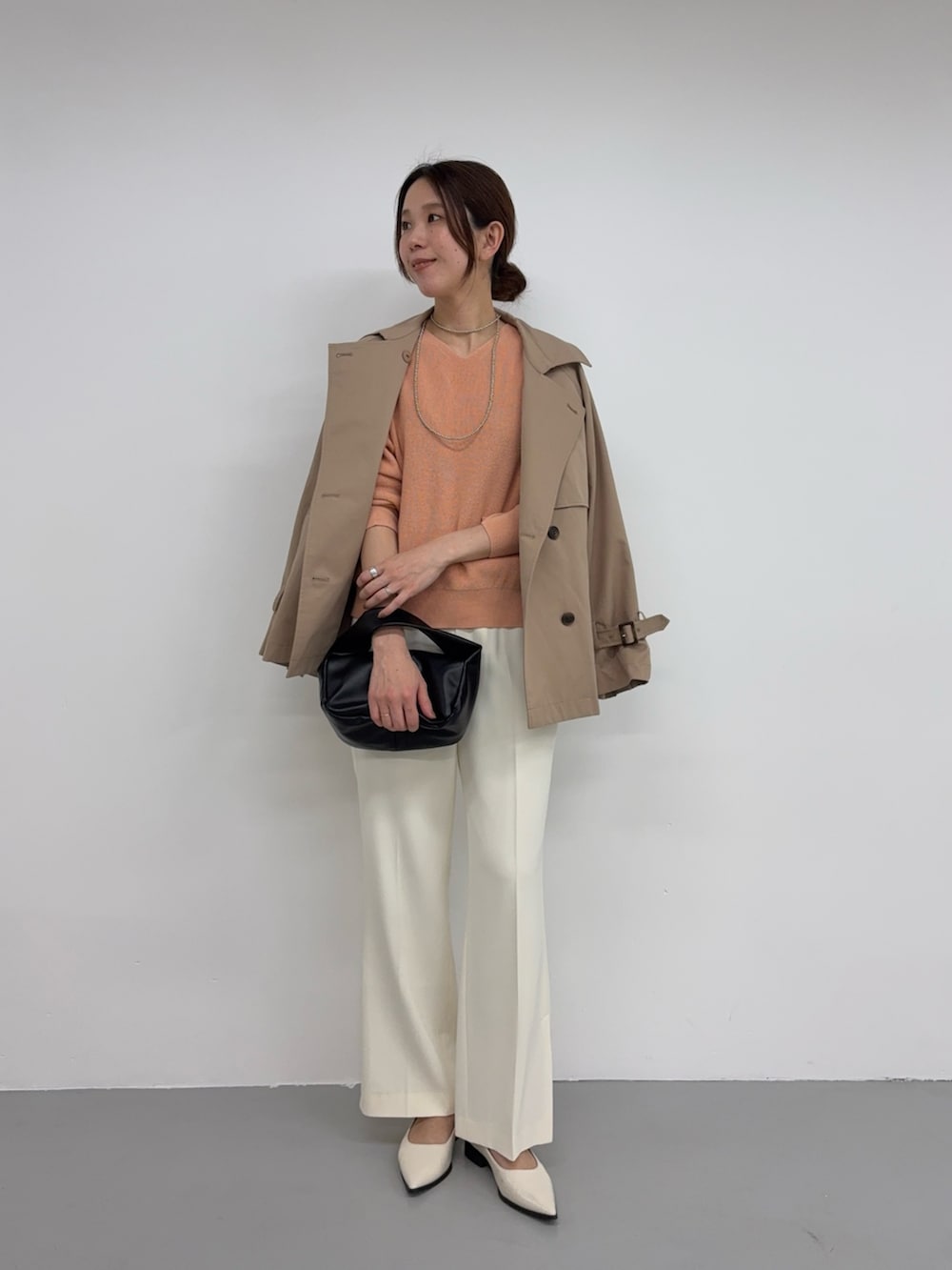 ピンク系のニット/セーター、ブラック系のハンドバッグ、ホワイト系のその他シューズを着用したレディースの冬コーディネートの2枚目の写真