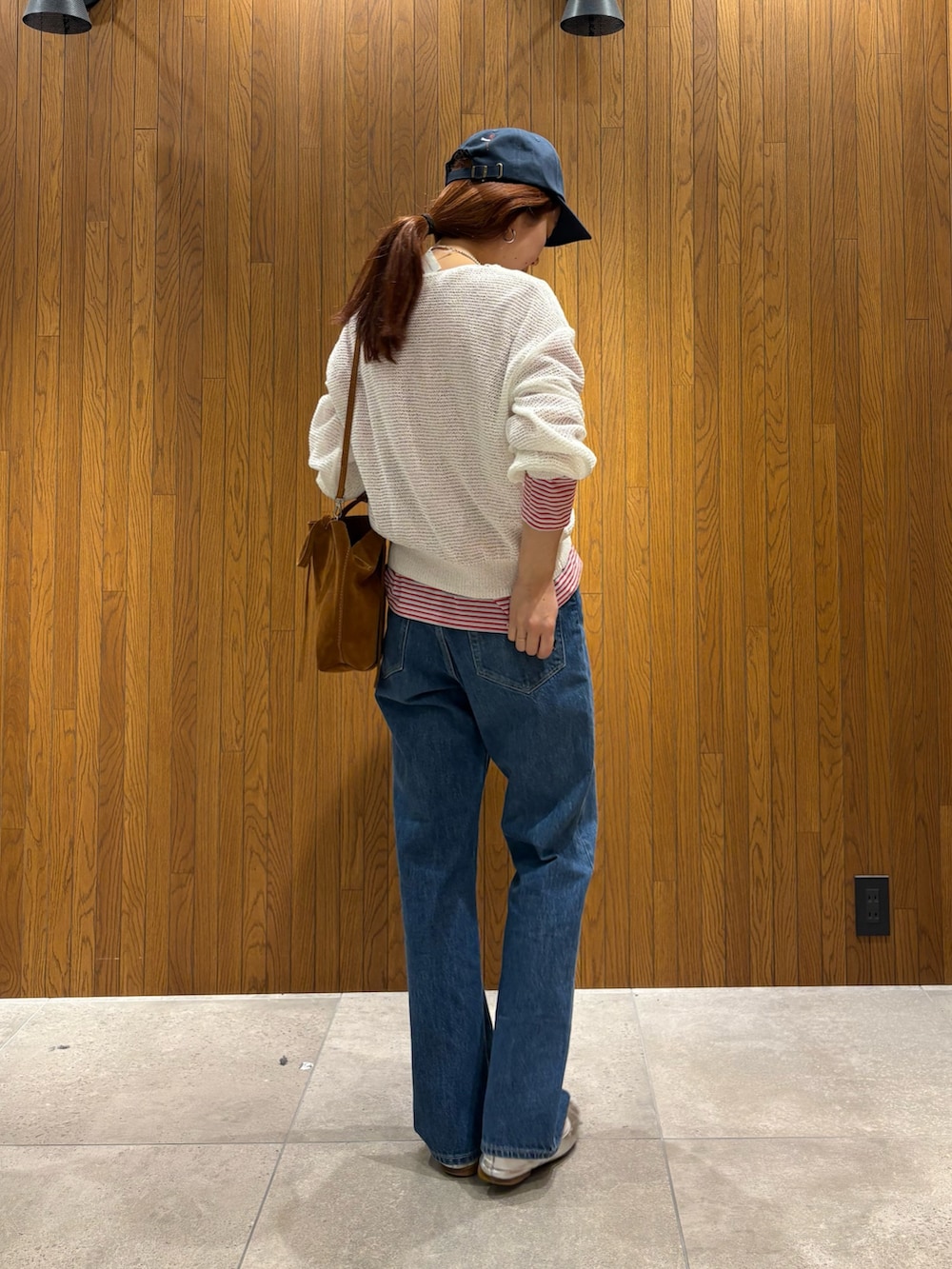 ベージュ系のトレンチコート、レッド系のTシャツ/カットソー、ホワイト系のニット/セーターを着用したレディースの春コーディネートの8枚目の写真