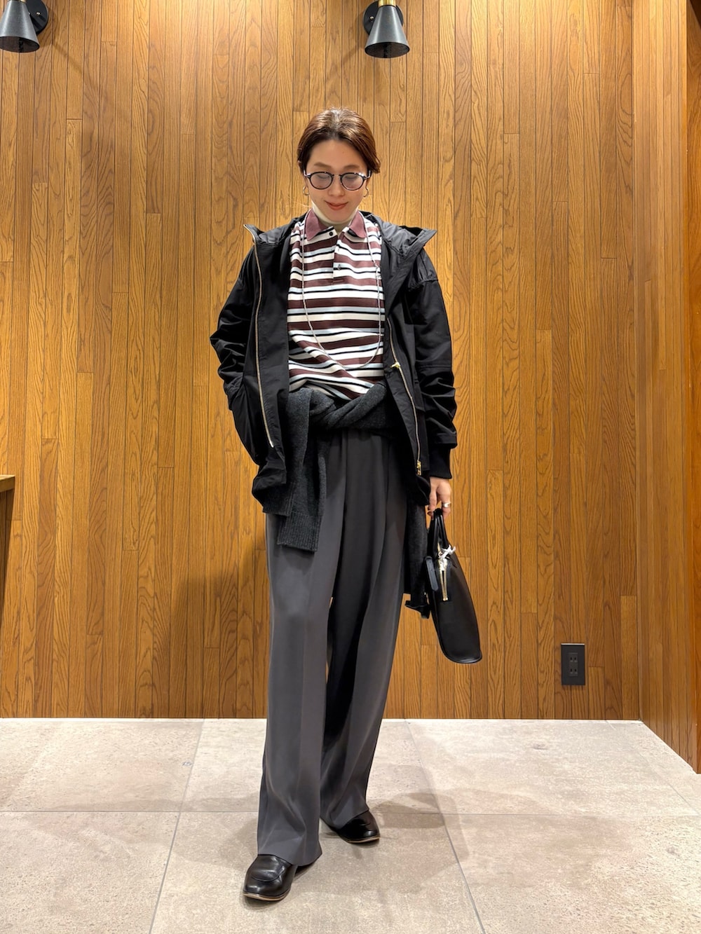 グレー系のその他パンツ、ブラック系のマウンテンパーカー、その他のポロシャツを着用したレディースの冬コーディネートの5枚目の写真