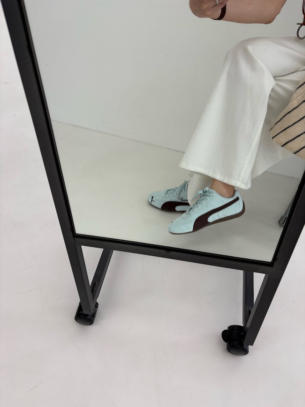 ホワイト系のデニムパンツ、ホワイト系のキャミソール、ホワイト系のタンクトップを着用したレディースの夏コーディネートの9枚目の写真