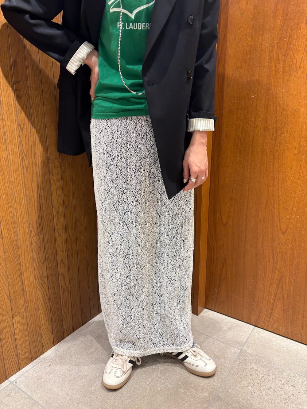 ホワイト系のスカート、ブラック系のその他アウター、ホワイト系のスニーカーを着用したレディースの冬コーディネートの4枚目の写真