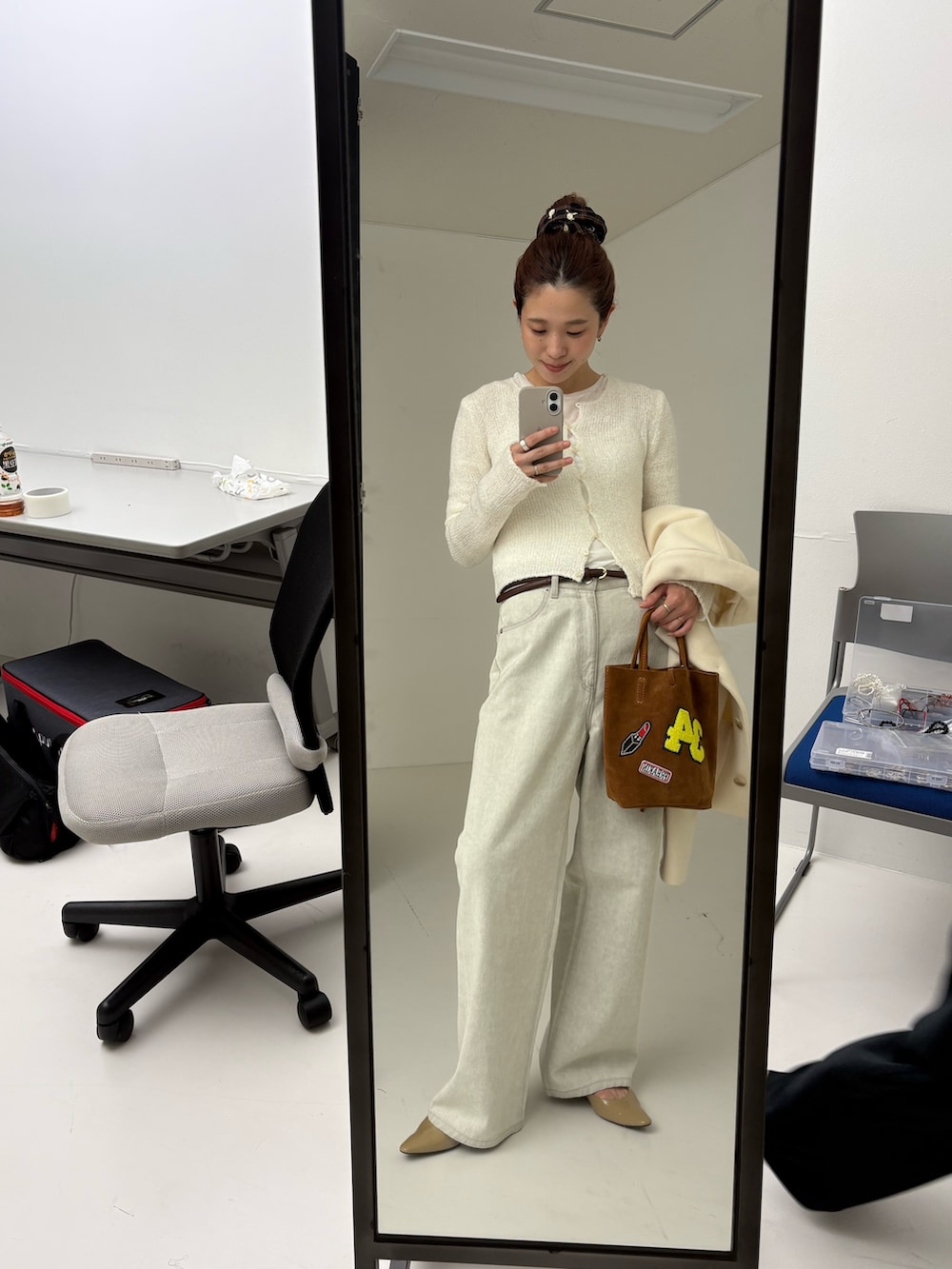 ホワイト系のその他アウター、ホワイト系のカーディガン/ボレロ、グレー系のデニムパンツを着用したレディースの秋コーディネートの9枚目の写真