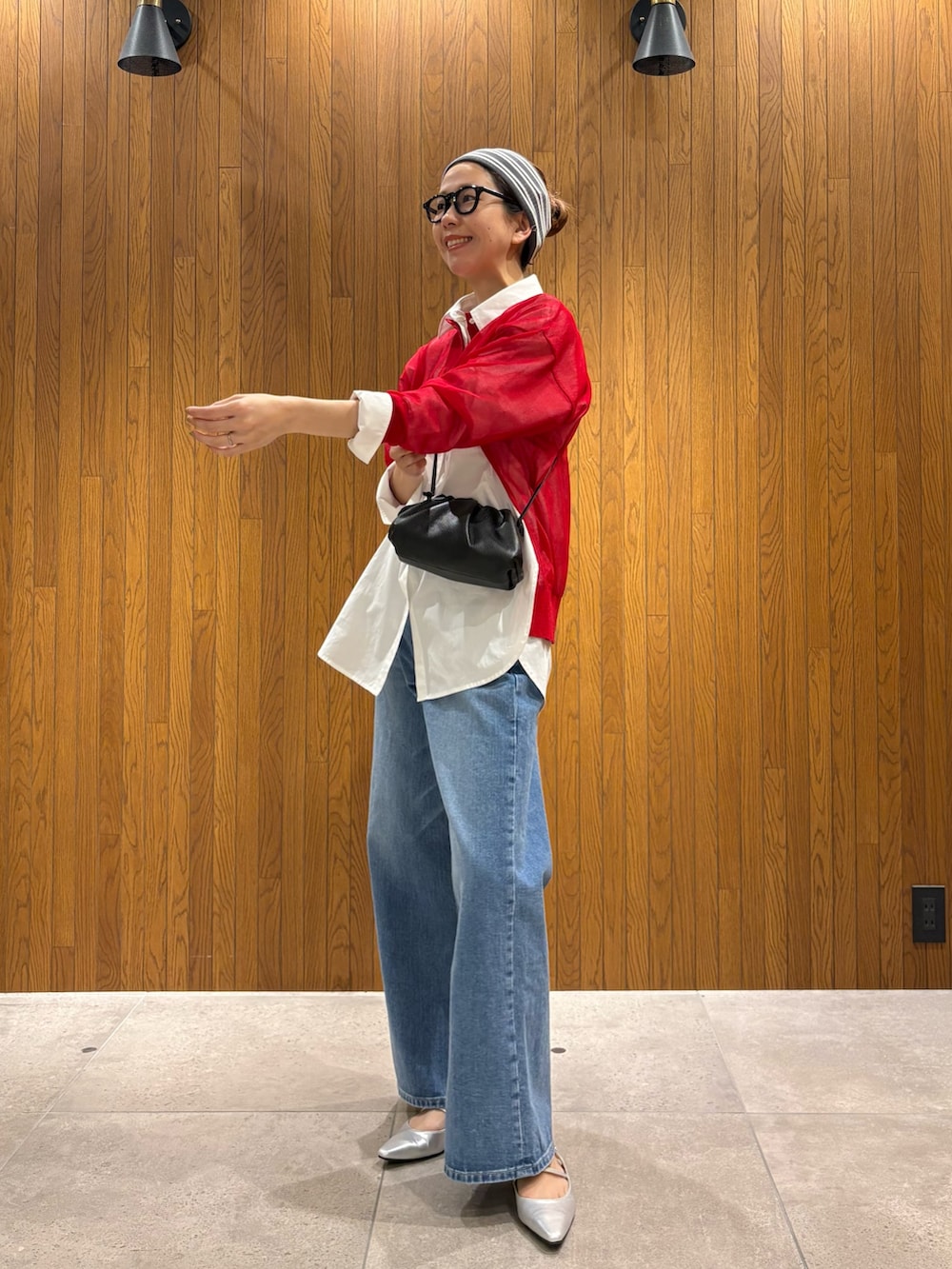 ベージュ系のトレンチコート、ブルー系のデニムパンツ、シルバー系のパンプスを着用したレディースの春コーディネートの8枚目の写真