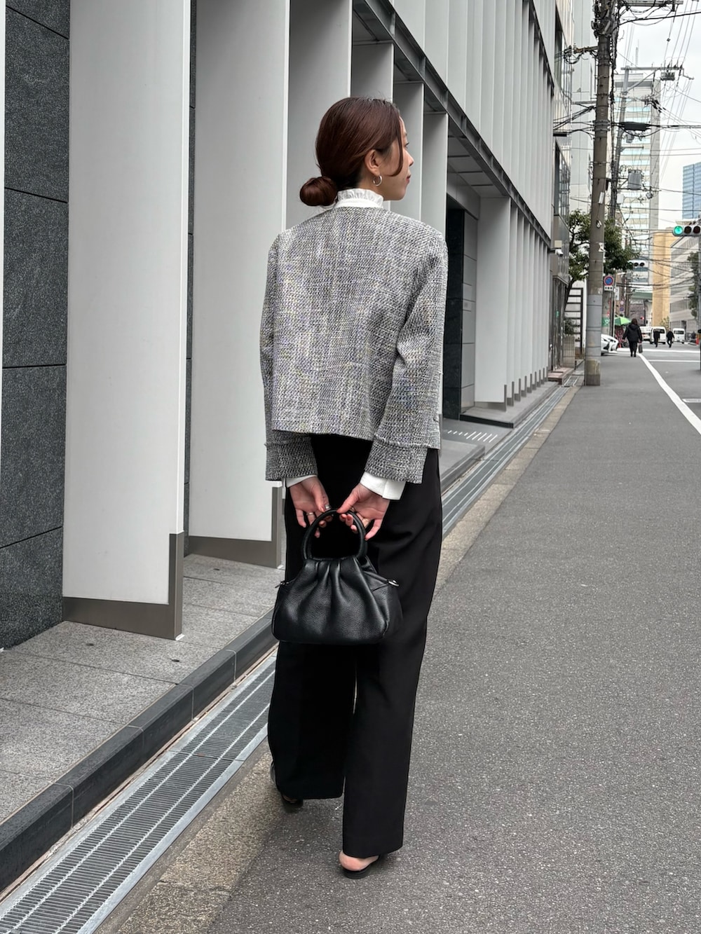 ブラック系のノーカラージャケット、ホワイト系のシャツ/ブラウス、ブラック系のその他パンツを着用したレディースの冬コーディネートの4枚目の写真