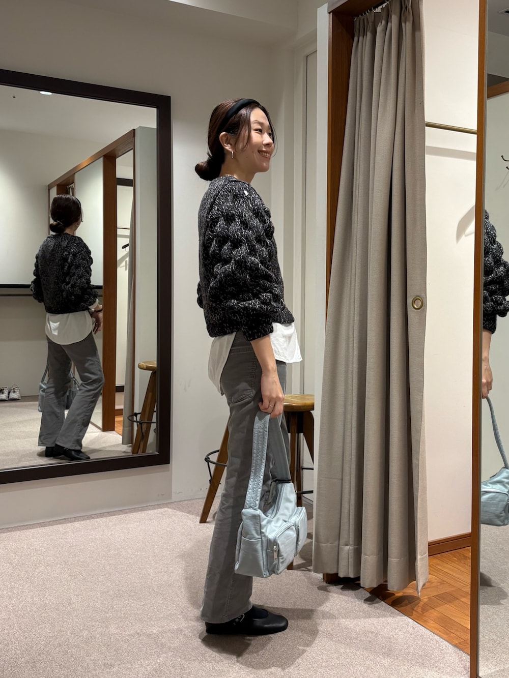 ブラック系のニット/セーター、グリーン系のショルダーバッグ、ブラック系のバレエシューズを着用したレディースの冬コーディネートの2枚目の写真