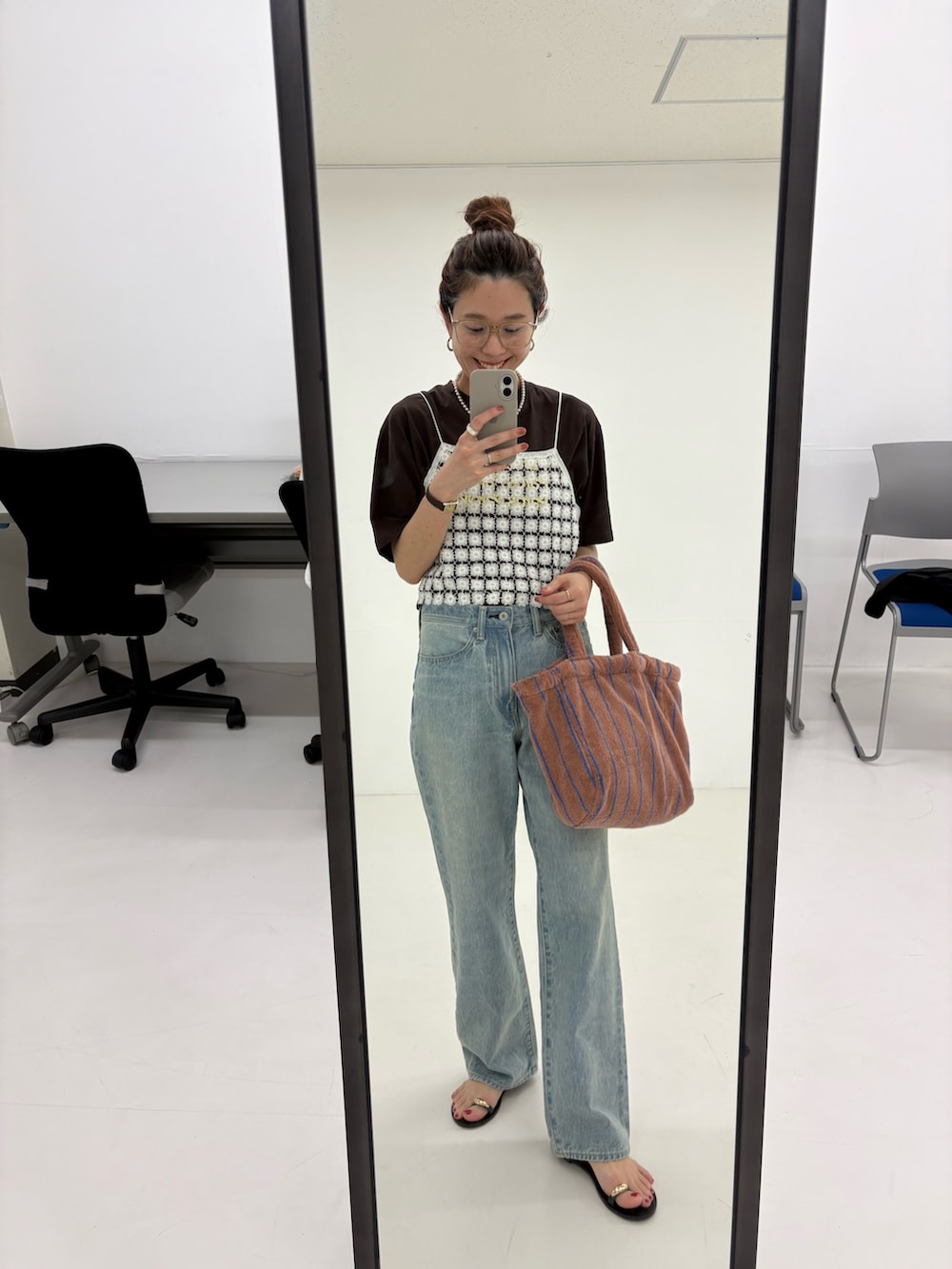ブルー系のデニムパンツ、ホワイト系のその他トップス、イエロー系のハンドバッグを着用したレディースの春コーディネートの9枚目の写真