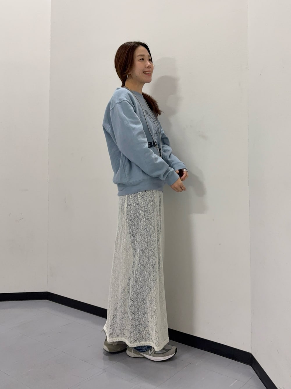 ホワイト系のスカート、ブルー系のスウェットを着用したレディースの冬コーディネートの2枚目の写真