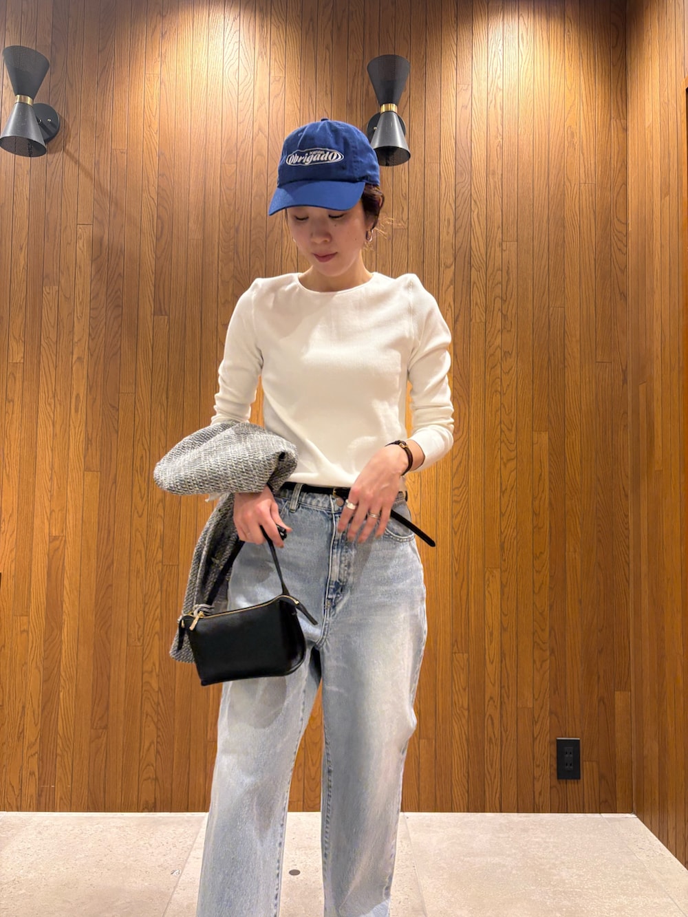 ブラック系のバレエシューズ、グレー系のデニムパンツ、ブラック系のハンドバッグを着用したレディースの冬コーディネートの7枚目の写真