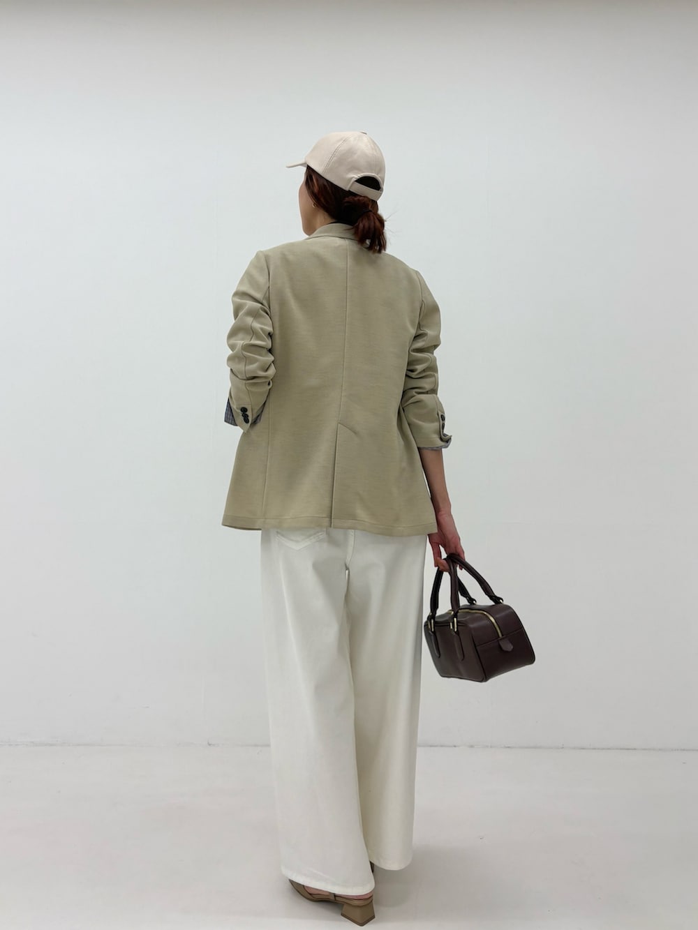 ベージュ系のその他アウター、ブルー系のシャツ/ブラウス、ホワイト系のデニムパンツを着用したレディースの春コーディネートの2枚目の写真