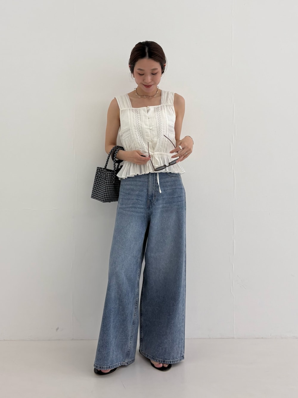 ブルー系のデニムパンツ、その他のトートバッグ、ホワイト系のシャツ/ブラウスを着用したレディースの夏コーディネートの7枚目の写真