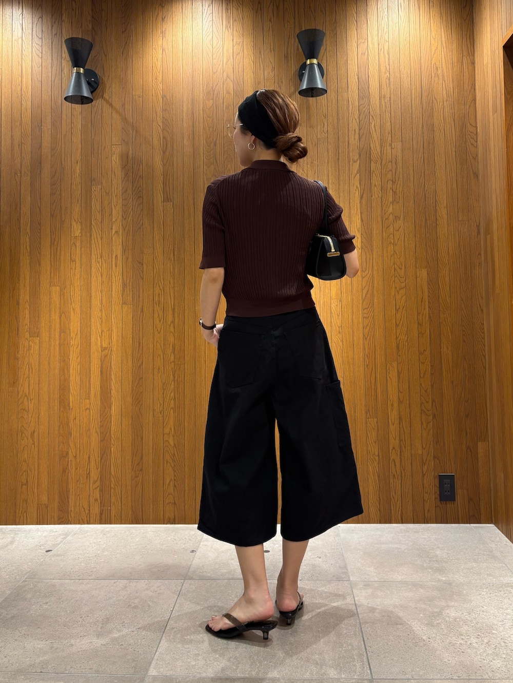 ブラウン系のニット/セーター、ブラック系のその他パンツ、ブラック系のサンダルを着用したレディースの夏コーディネートの3枚目の写真
