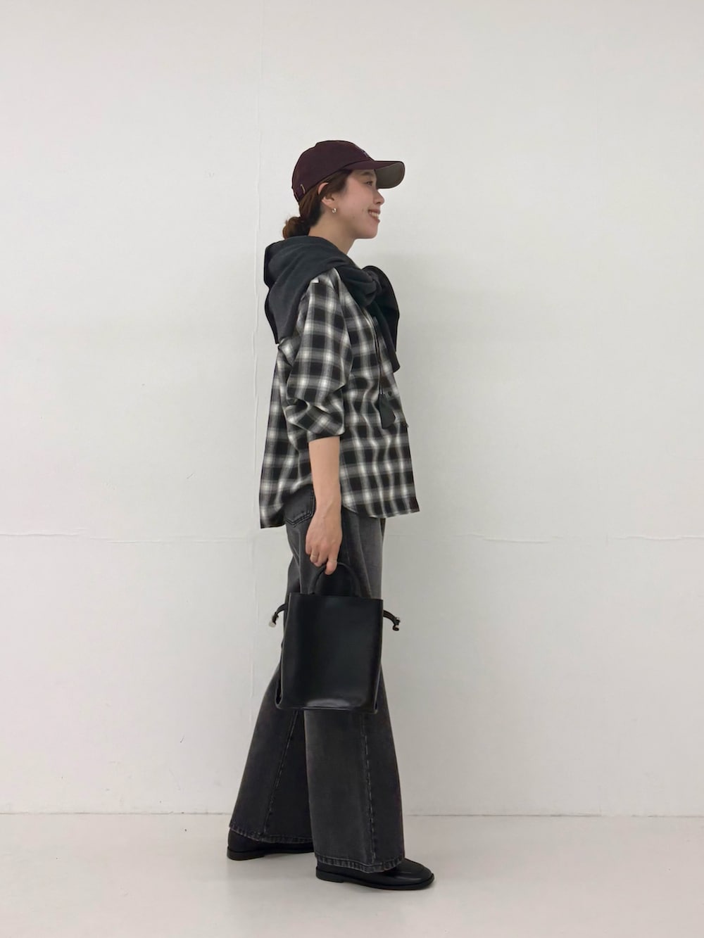 ブラック系のシャツ/ブラウス、ブラック系のデニムパンツ、ブラック系のショルダーバッグを着用したレディースの秋コーディネートの4枚目の写真