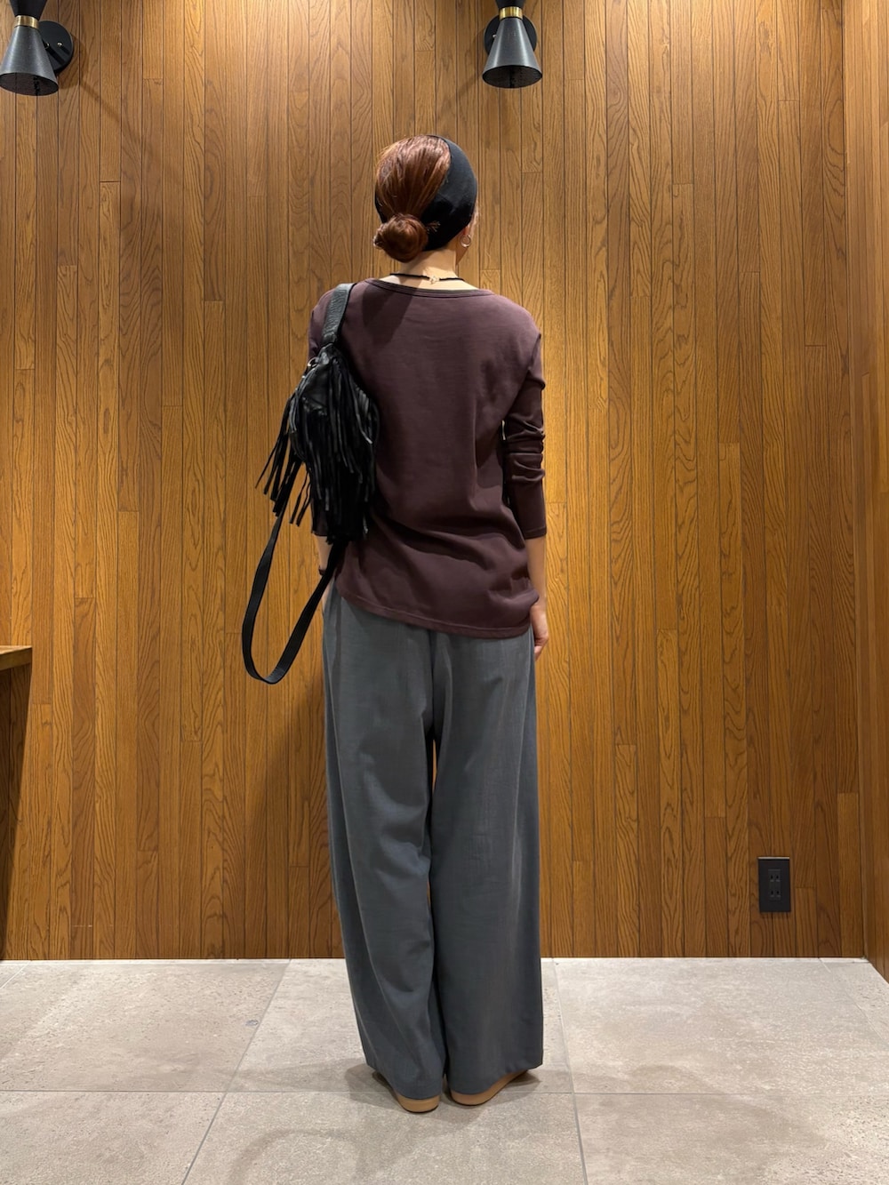 グレー系のその他パンツ、シルバー系のスニーカー、ブラック系のハンドバッグを着用したレディースの春コーディネートの4枚目の写真