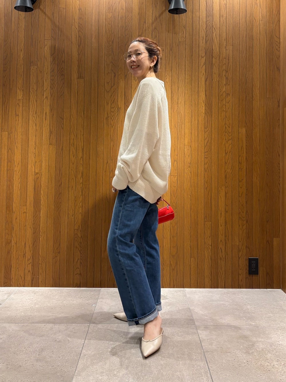 ベージュ系のニット/セーター、ホワイト系のTシャツ/カットソー、レッド系のハンドバッグを着用したレディースの秋コーディネートの2枚目の写真