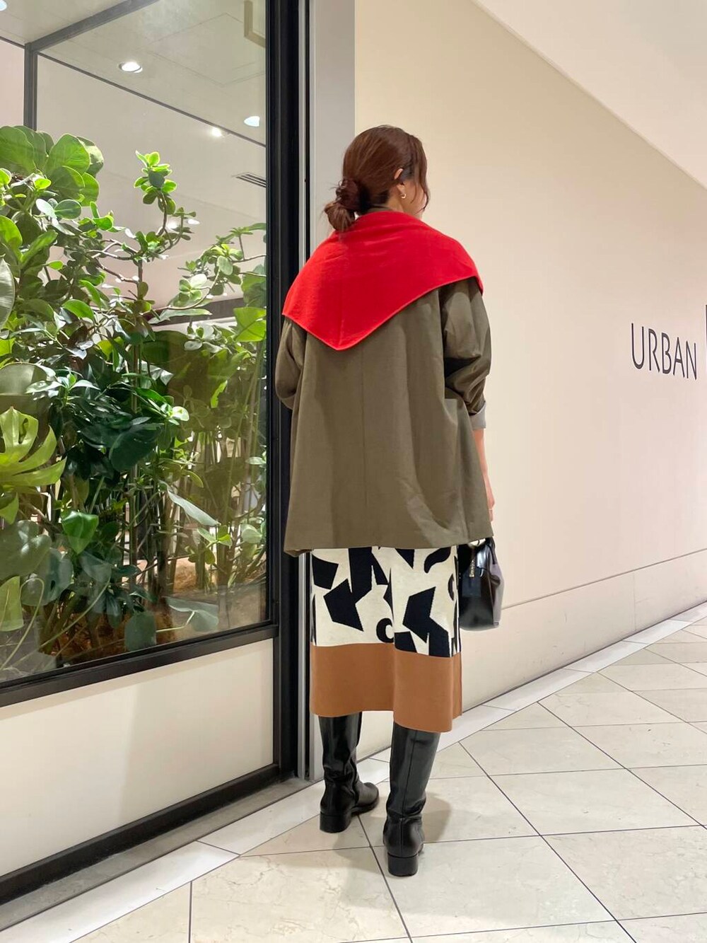 ブラック系のショルダーバッグ、ブラウン系のその他アウター、ホワイト系のニット/セーターを着用したレディースの秋コーディネートの3枚目の写真