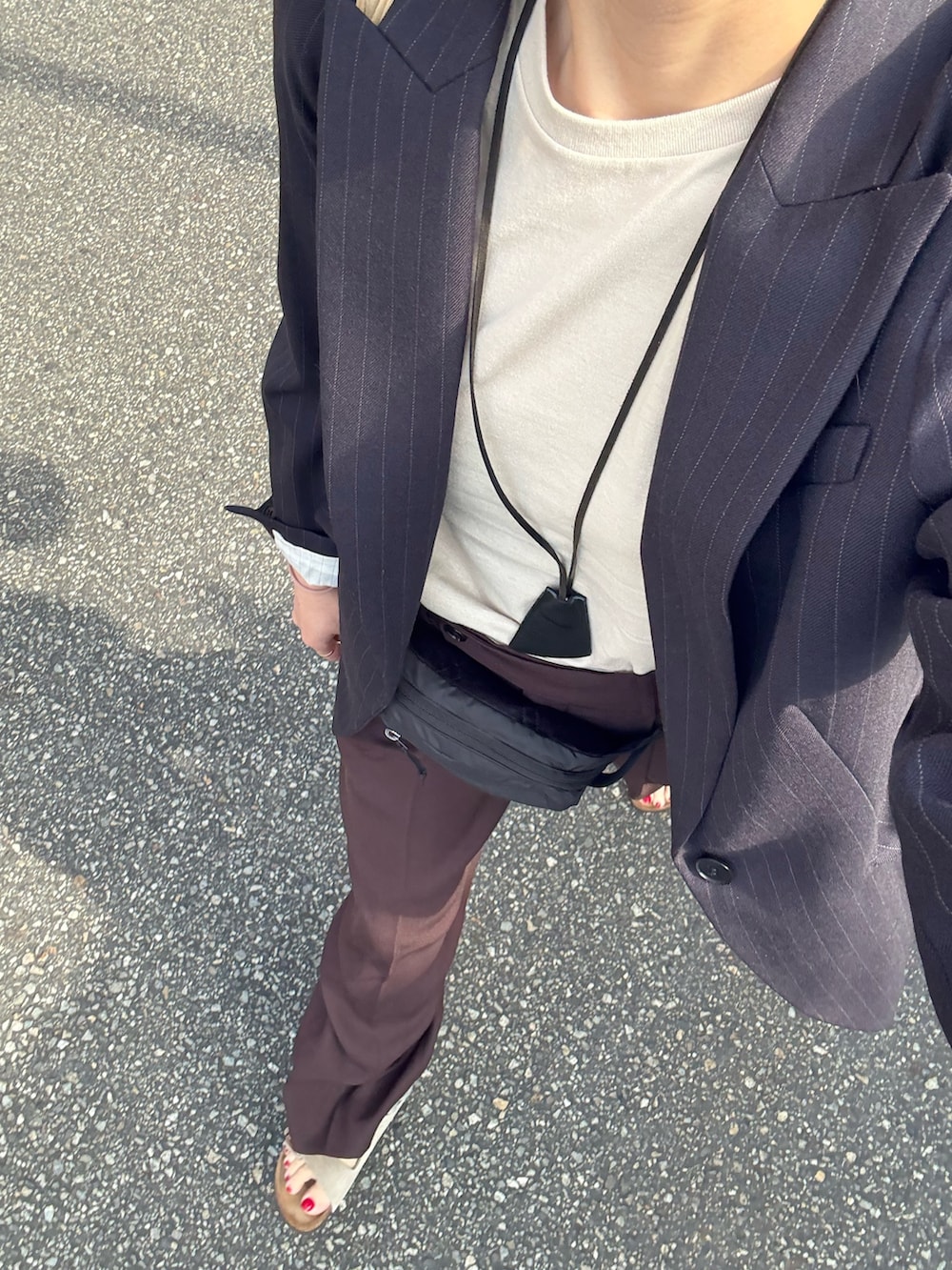 その他のTシャツ/カットソー、ブラウン系のその他パンツ、ベージュ系のサンダルを着用したレディースの春コーディネートの5枚目の写真