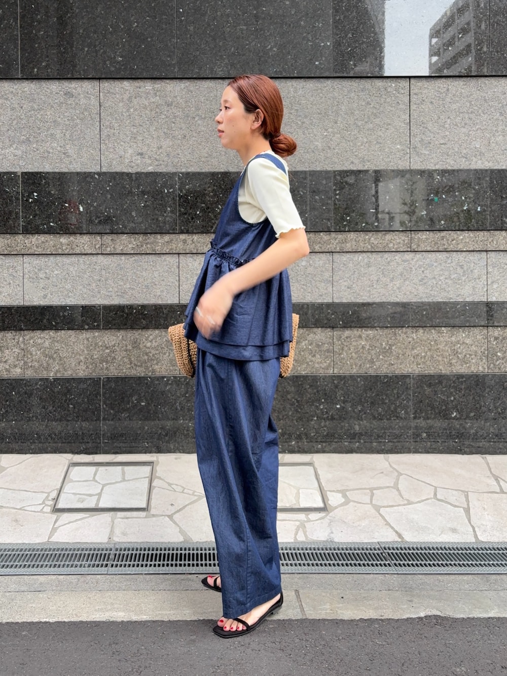 ブルー系のサロペット/オーバーオール、ベージュ系のトートバッグ、ホワイト系のTシャツ/カットソーを着用したレディースの春コーディネートの2枚目の写真