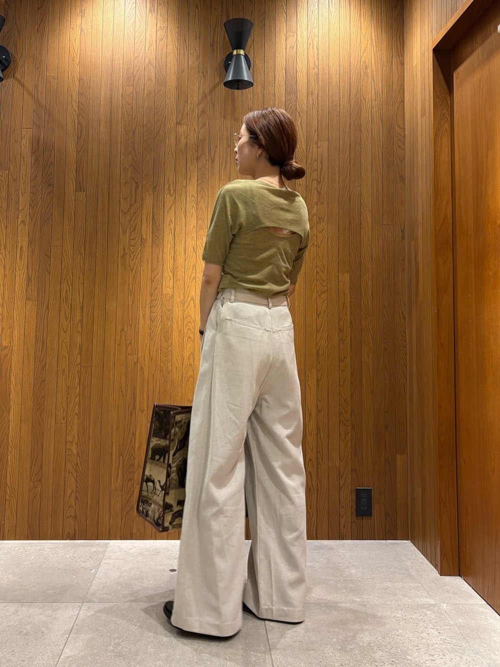 ホワイト系のその他パンツ、グリーン系のTシャツ/カットソー、ベージュ系のハンドバッグを着用したレディースの春コーディネートの3枚目の写真