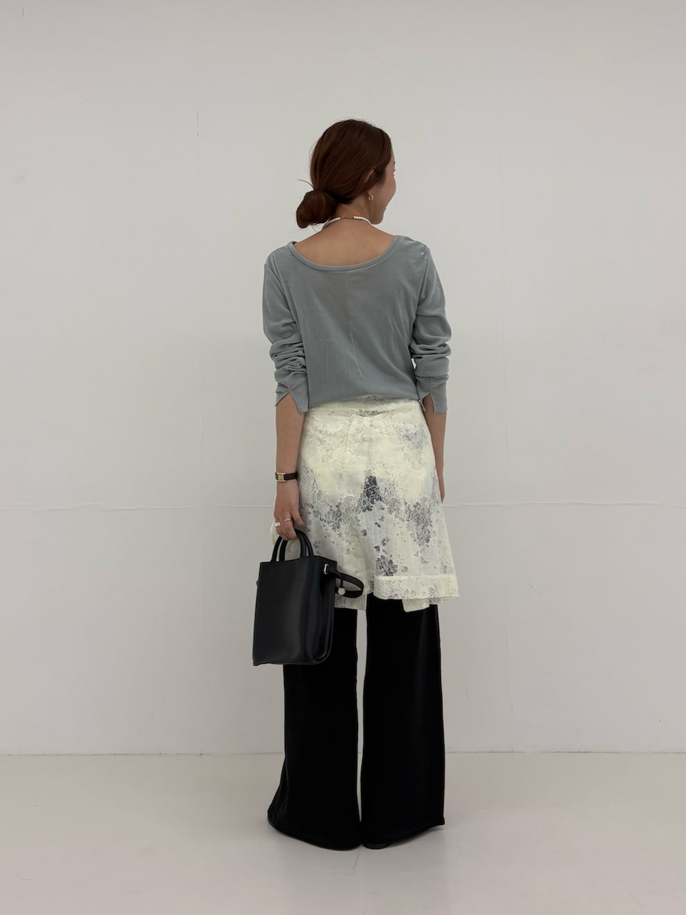ブラック系のデニムパンツ、ホワイト系のシャツ/ブラウス、ブラック系のショルダーバッグを着用したレディースの夏コーディネートの4枚目の写真