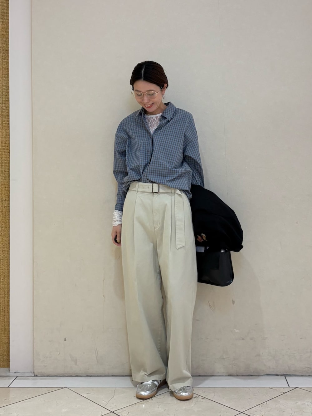 ブラック系のその他アウター、ベージュ系のその他パンツ、シルバー系のスニーカーを着用したレディースの春コーディネートの6枚目の写真