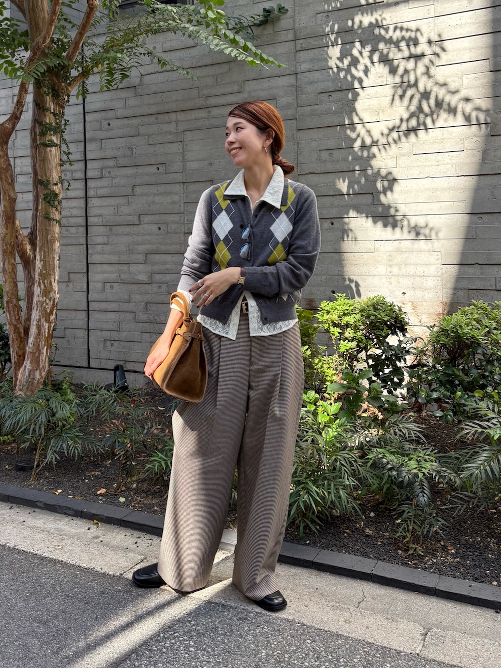 グレー系のニット/セーター、ホワイト系のシャツ/ブラウス、グレー系のその他パンツを着用したレディースの秋コーディネートの6枚目の写真