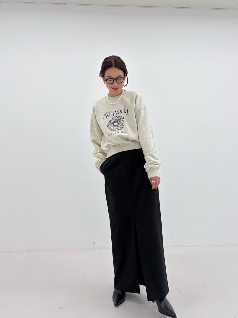 ブラック系のスカート、ブラック系のショルダーバッグ、グリーン系のその他アウターを着用したレディースの秋コーディネートの9枚目の写真