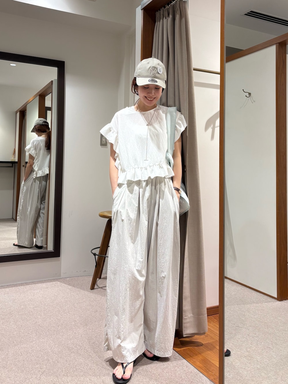 ホワイト系のTシャツ/カットソー、グレー系のその他パンツ、ブラック系のサンダルを着用したレディースの夏コーディネートの5枚目の写真