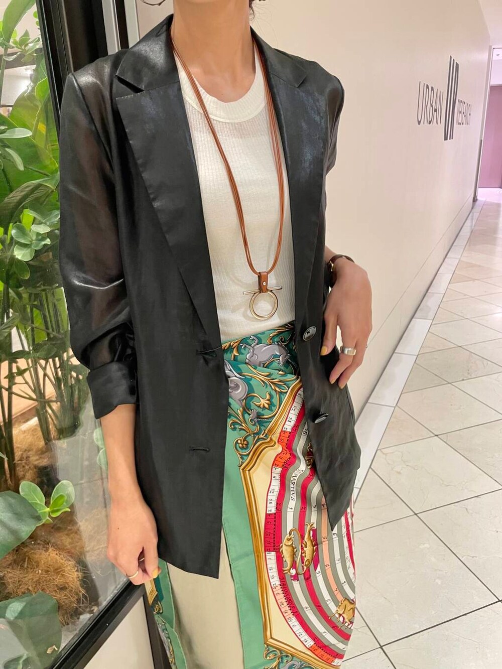 ホワイト系のタンクトップ、ブラック系のテーラードジャケット、ベージュ系のチノパンツを着用したレディースの夏コーディネートの6枚目の写真