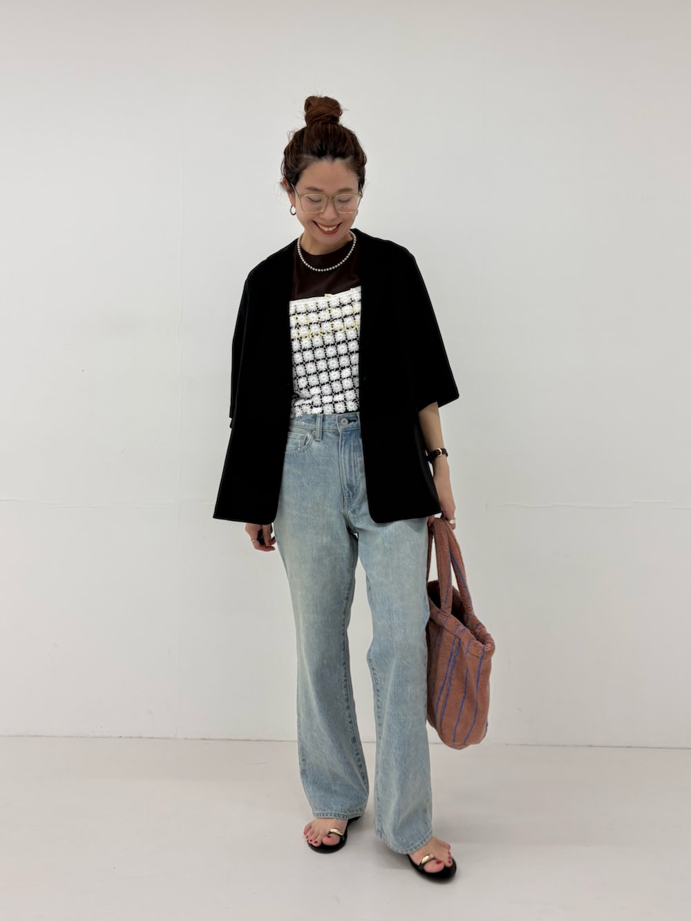 ブルー系のデニムパンツ、ホワイト系のその他トップス、イエロー系のハンドバッグを着用したレディースの春コーディネートの5枚目の写真