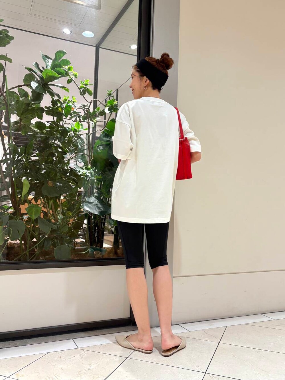 レッド系のショルダーバッグ、ホワイト系のTシャツ/カットソー、ブラック系の水着を着用したレディースの春コーディネートの3枚目の写真