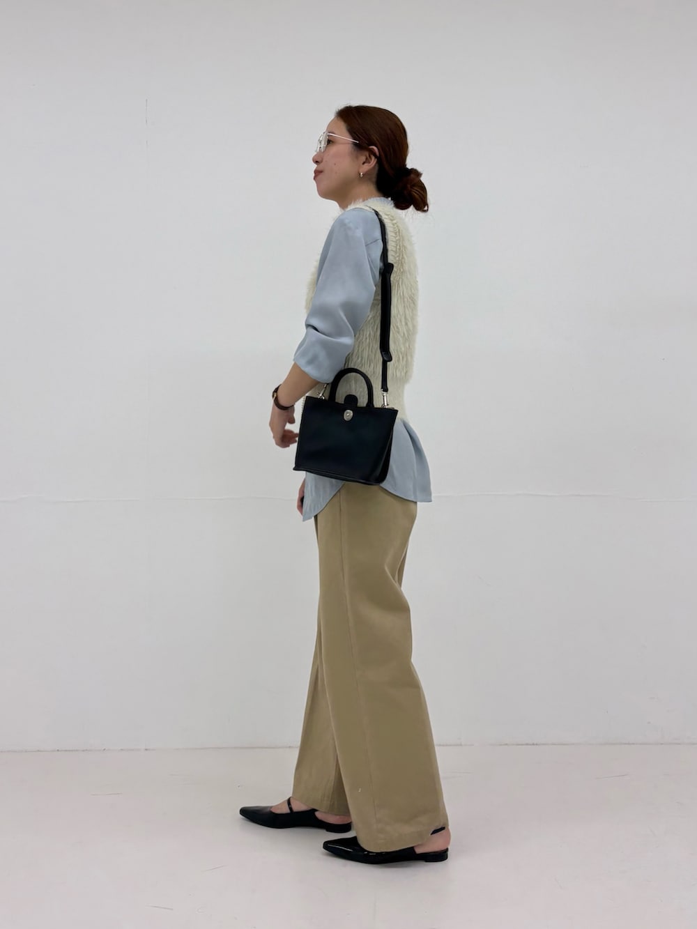 ホワイト系のベスト、ベージュ系のその他パンツ、ブルー系のシャツ/ブラウスを着用したレディースの秋コーディネートの2枚目の写真