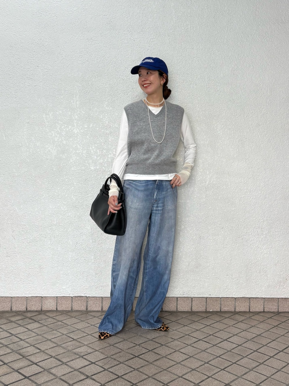 ブルー系のその他パンツ、グレー系のニット/セーター、ホワイト系のTシャツ/カットソーを着用したレディースの秋コーディネートの6枚目の写真